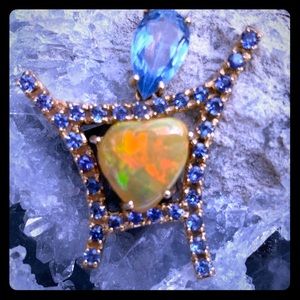 3+ carat opal pendant with sapphires set in gold.